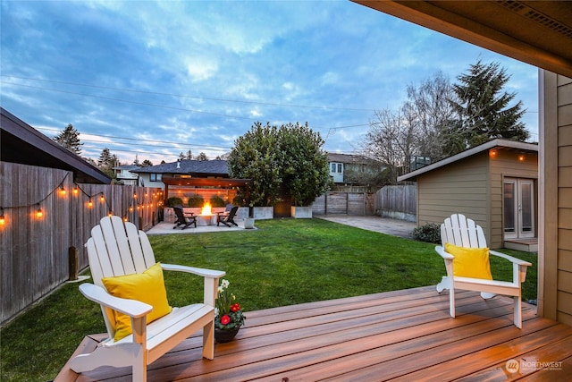 view of yard featuring a patio, a deck, and a fire pit