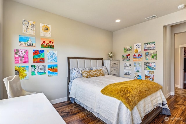 bedroom with dark hardwood / wood-style flooring