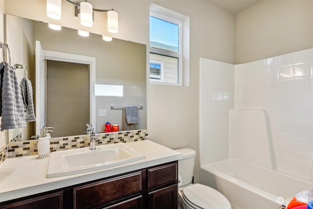 full bathroom with vanity, shower / bathing tub combination, backsplash, and toilet