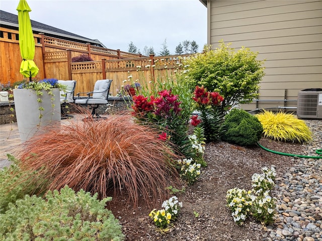 view of yard featuring central AC unit and a patio area