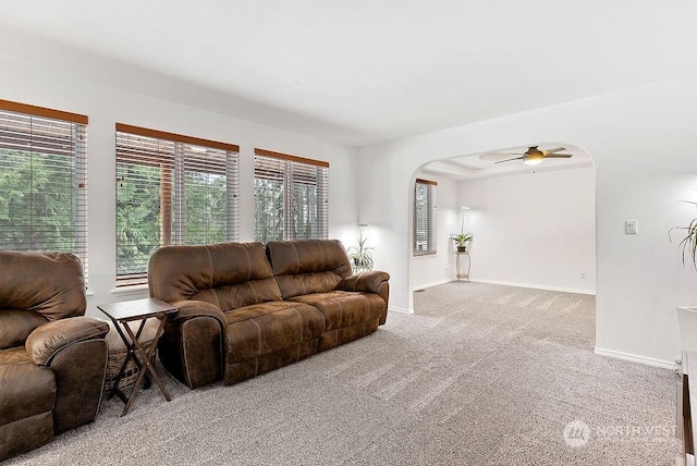 carpeted living room featuring ceiling fan