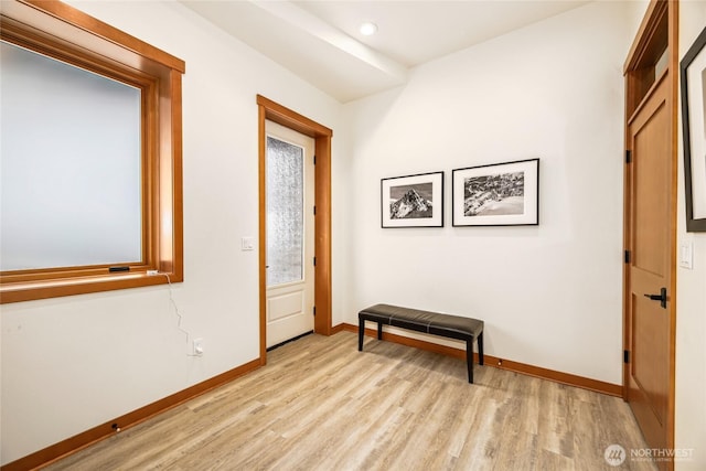 hallway with light hardwood / wood-style flooring