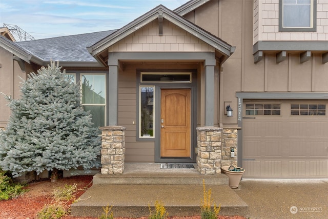 doorway to property with a garage