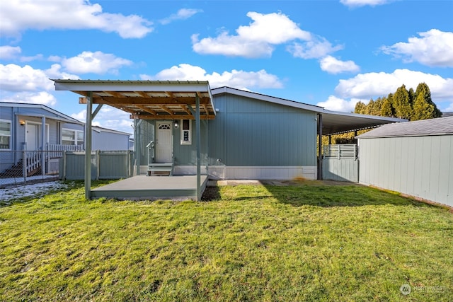 rear view of property with a lawn