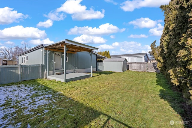 view of yard with a storage shed and a patio area