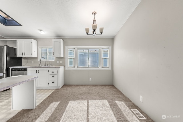 kitchen featuring pendant lighting, dishwasher, white cabinetry, sink, and an inviting chandelier