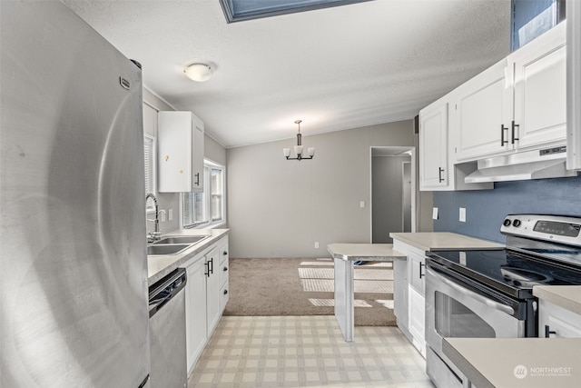 kitchen featuring sink, appliances with stainless steel finishes, white cabinets, decorative light fixtures, and a chandelier