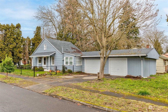 view of front of property with a garage and a front lawn