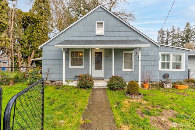 bungalow-style house featuring a front yard and covered porch