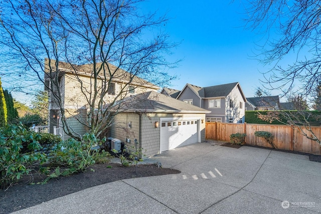 view of property exterior featuring central AC unit and a garage