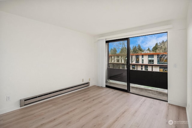 unfurnished room with light hardwood / wood-style flooring and a baseboard radiator