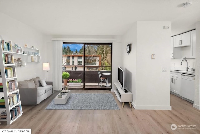 living room with sink and light wood-type flooring