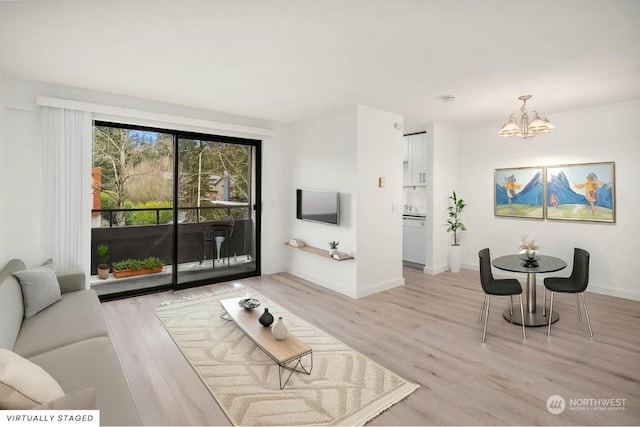 living room featuring light hardwood / wood-style floors and a chandelier