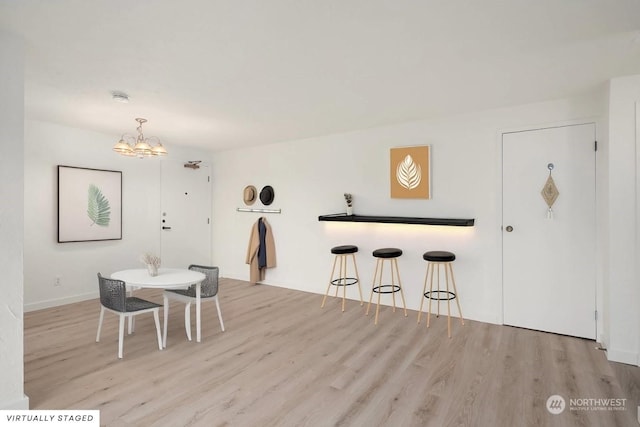 dining area featuring a chandelier and light hardwood / wood-style floors