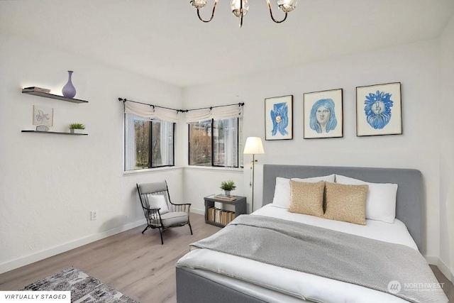 bedroom with hardwood / wood-style flooring and a chandelier