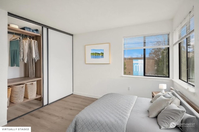 bedroom featuring a closet and light wood-type flooring