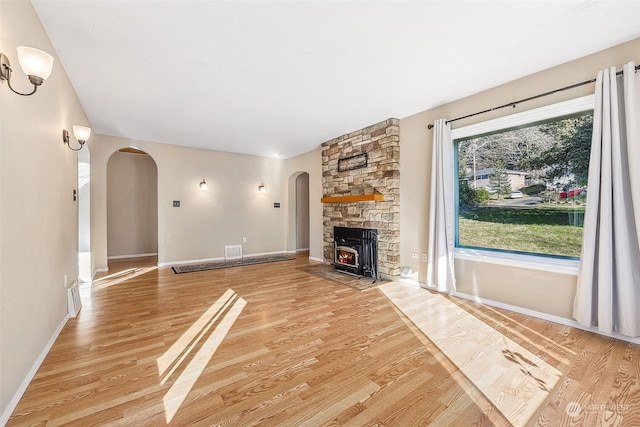 unfurnished living room featuring a fireplace and light wood-type flooring