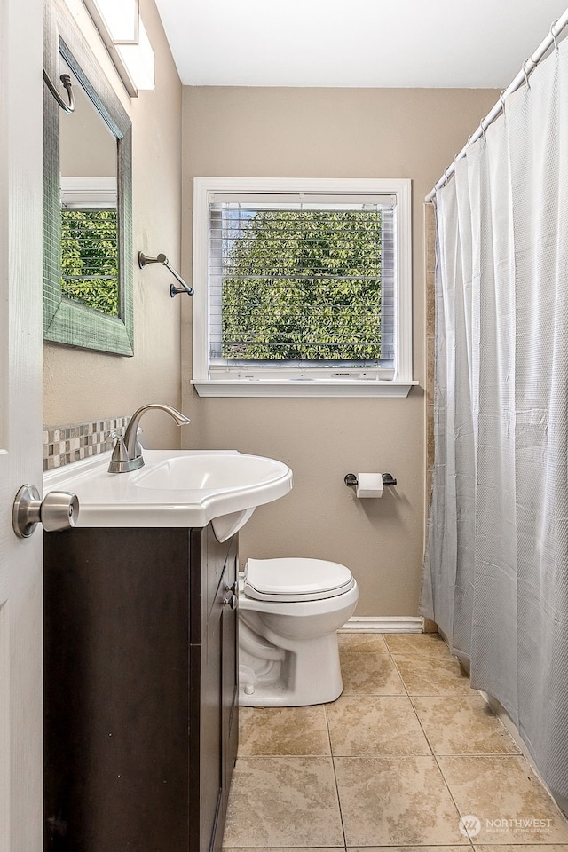 bathroom featuring tile patterned flooring, vanity, and toilet