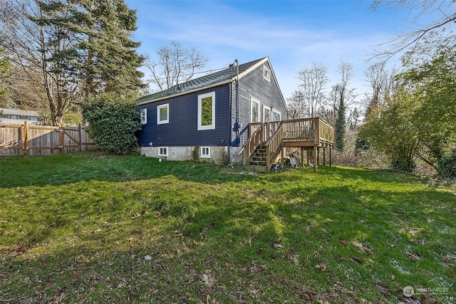 view of property exterior with a wooden deck and a lawn