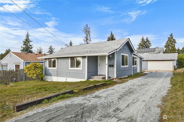 view of front of property with a garage and a front lawn