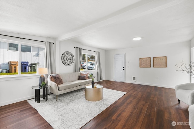 living room featuring beamed ceiling and hardwood / wood-style floors