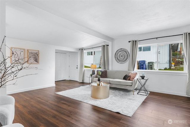 living room featuring plenty of natural light, dark hardwood / wood-style flooring, and lofted ceiling with beams