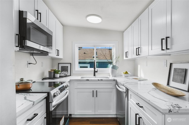 kitchen featuring white cabinetry, sink, and appliances with stainless steel finishes