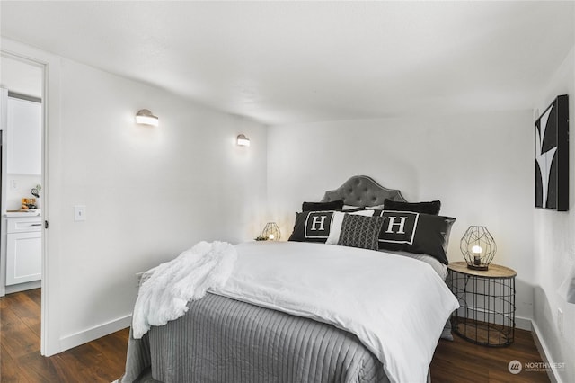 bedroom with dark hardwood / wood-style floors