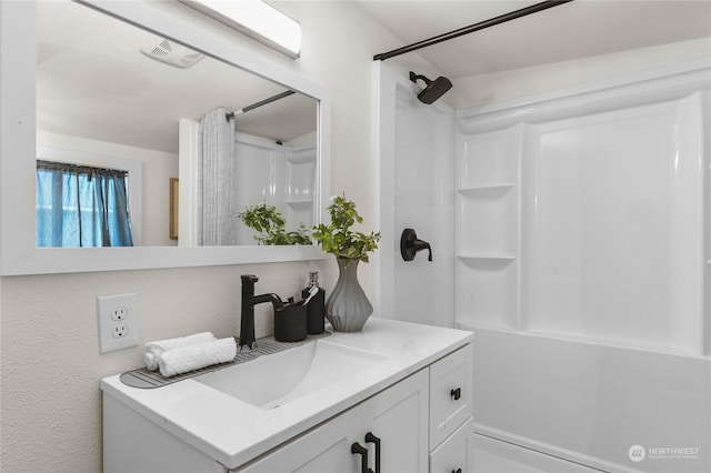 bathroom with vanity and a shower