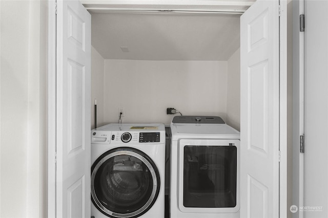 laundry room with washing machine and clothes dryer