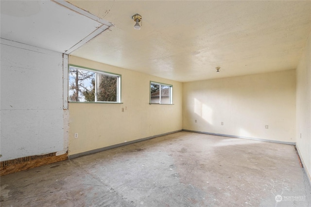 unfurnished room featuring concrete floors