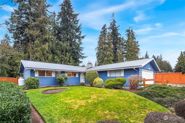 single story home featuring a garage and a front yard