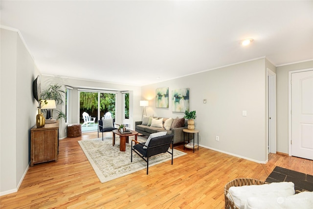 living room with light hardwood / wood-style flooring and ornamental molding