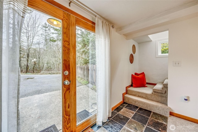 doorway to outside with stairway, stone tile flooring, and baseboards