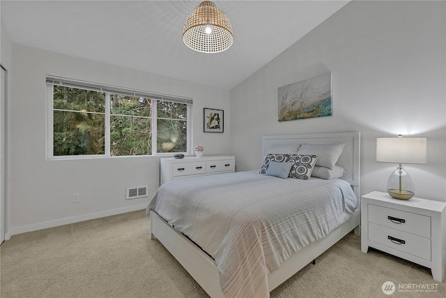 bedroom featuring light colored carpet, visible vents, vaulted ceiling, and baseboards