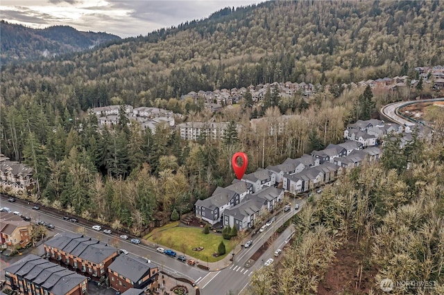 bird's eye view with a wooded view and a residential view