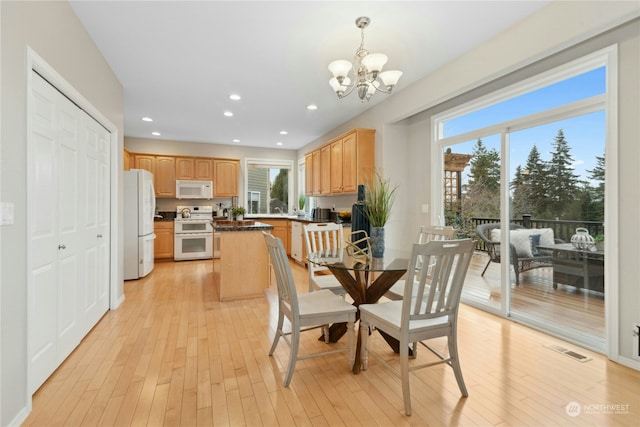 dining room featuring an inviting chandelier and light hardwood / wood-style floors