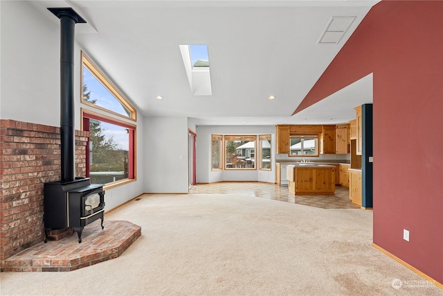 912 Bell Dr, Cosmopolis, WA 98537 - living room featuring baseboards, visible vents, light colored carpet, a wood stove, and recessed lighting