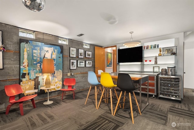 carpeted dining area featuring wine cooler