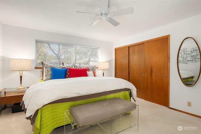 carpeted bedroom featuring ceiling fan and a closet