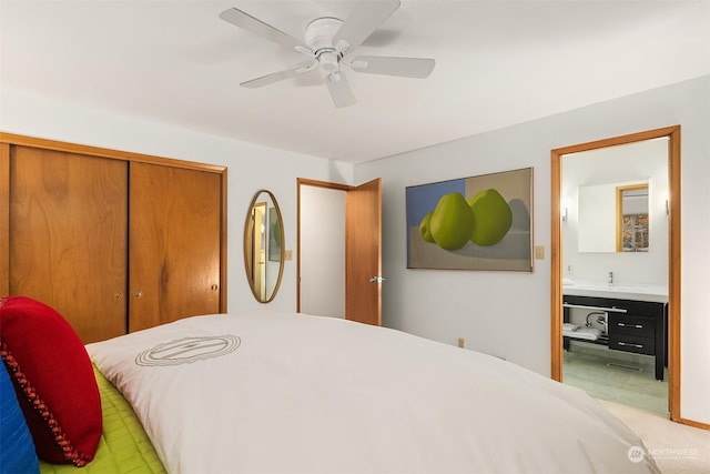 bedroom with a closet, ceiling fan, and ensuite bathroom