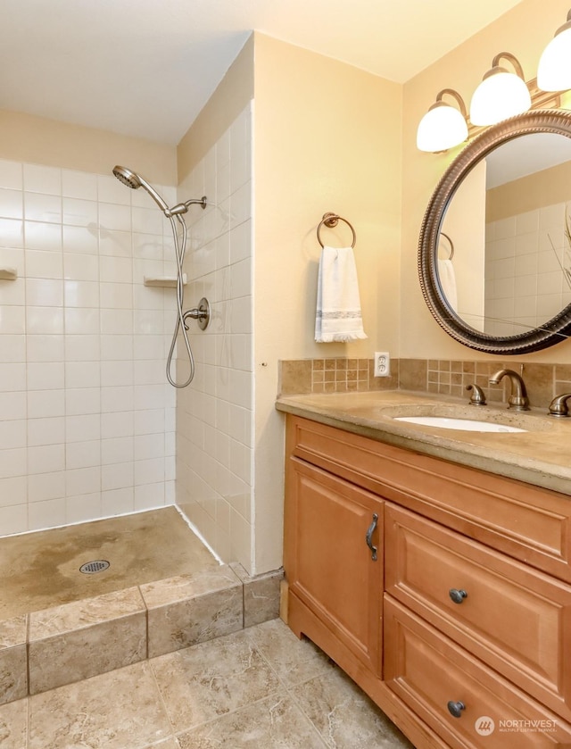 bathroom featuring vanity and tiled shower