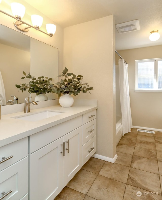 bathroom with tile patterned flooring, vanity, and shower / tub combo