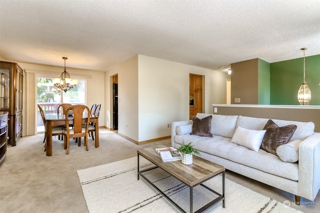 carpeted living room featuring a textured ceiling and a chandelier