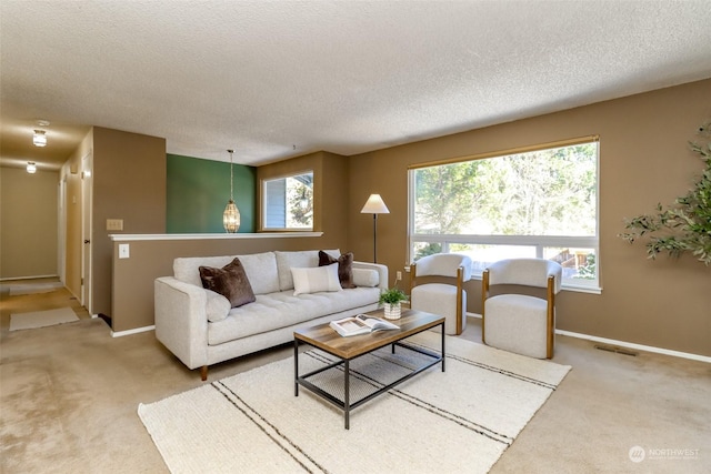 living room featuring carpet flooring and a textured ceiling