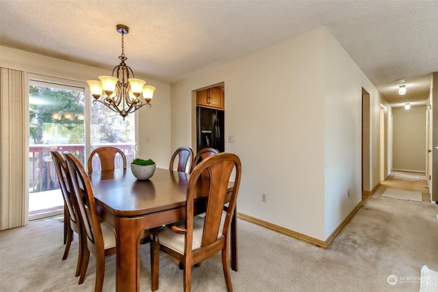 carpeted dining space with a notable chandelier and a textured ceiling