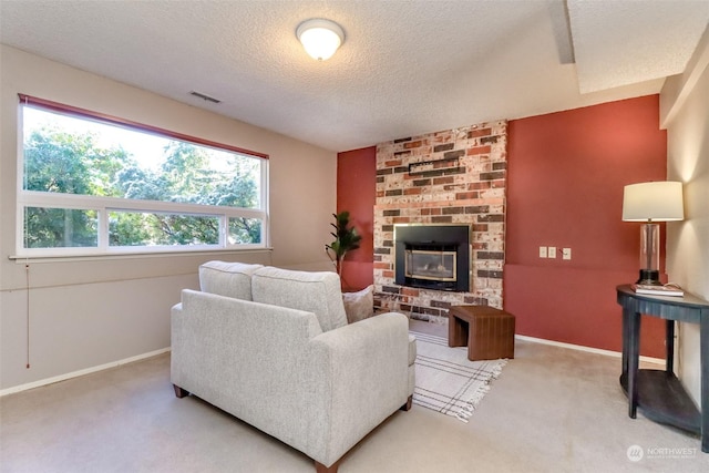 living room with carpet floors, a textured ceiling, and a fireplace