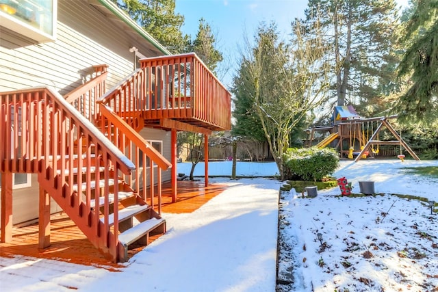 yard covered in snow featuring a deck