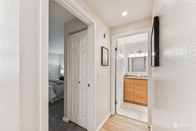 hallway with light hardwood / wood-style flooring