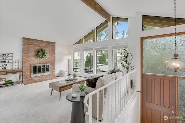 carpeted living room featuring beamed ceiling, high vaulted ceiling, and a fireplace